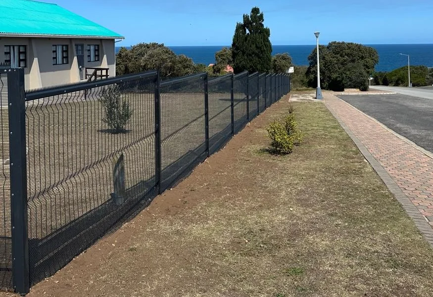 Newly installed metal boundary fence panels on a residential property
